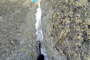 Finn climbing the narrow ice feature which proved too brittle